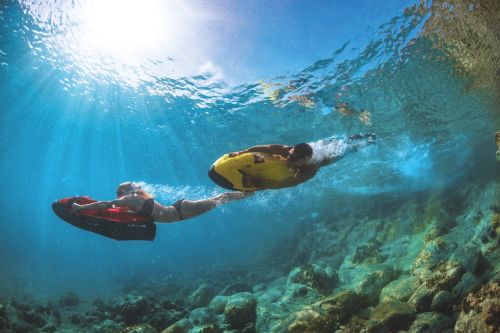 Two people in the water with a seabob, one of the best water toys for a yacht charter