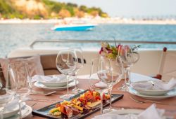 A table set up for lunch on the aft deck of a yacht