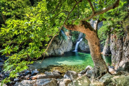 A waterfall surrounded by sunshine on the mountainous island of Samothrace in Greece