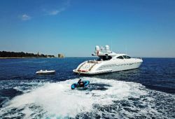 A Mangusta sports yacht at anchor with her tender