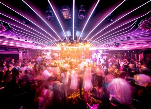 Party atmosphere and people dancing at the Caves du Roy, the nightclub of the mythical Byblos hotel in St Tropez