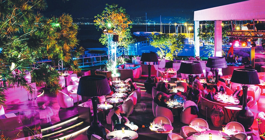 The terrace of Medusa illuminated with pink lights during an evening party in Cannes 