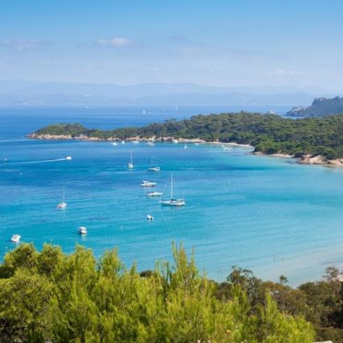 A superb bay anchorage with charter yachts at anchor on the island of Porquerolles in the south of France