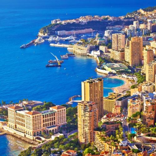 Aerial view of Monaco and its buildings with the entrance of Port Hercule