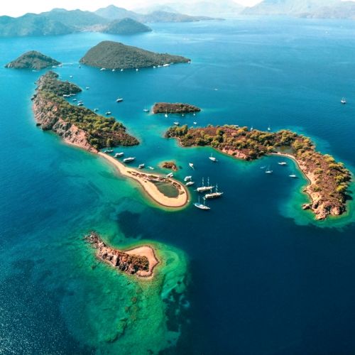 Paradise islands off Gcek in Turkey with charter yachts at anchor