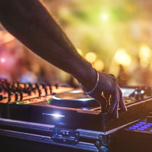 A DJ playing in front of a crowd at a party in Mykonos in the Cyclades Islands in Greece