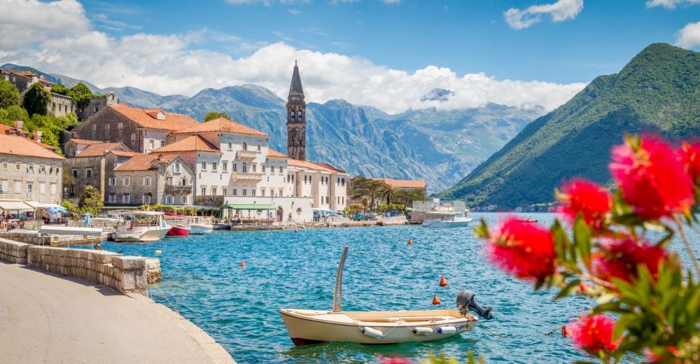 The coastal town of Perast in Montenegro on a beautiful sunny day with small moored boats