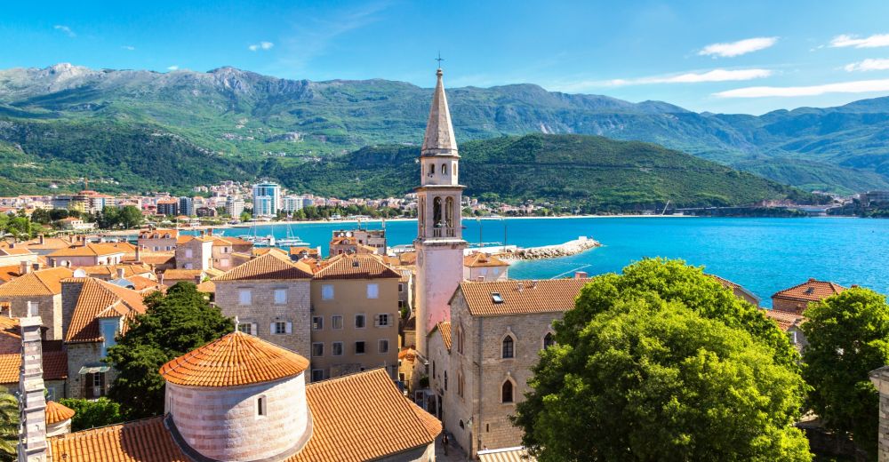 The old town of Budva with red tile roofs and its bell tower in Montenegro