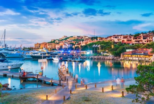 The marina of Porto Cervo in Sardinia at nightfall with moored yachts