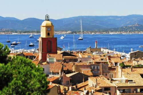 Panorama of the village of St Tropez with its bell tower and yachts at anchor in the bay