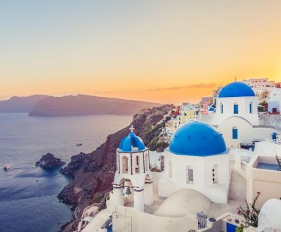 The beautiful coastal town of Oia on Santorini island in Greece with white buildings and blue domes