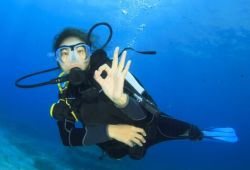 Woman scuba diving during a Mediterranean yacht charter