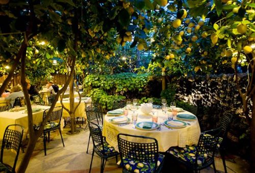 A  table set up for dinner under the lemon trees at Da Paolino, one of the best restaurants in Capri