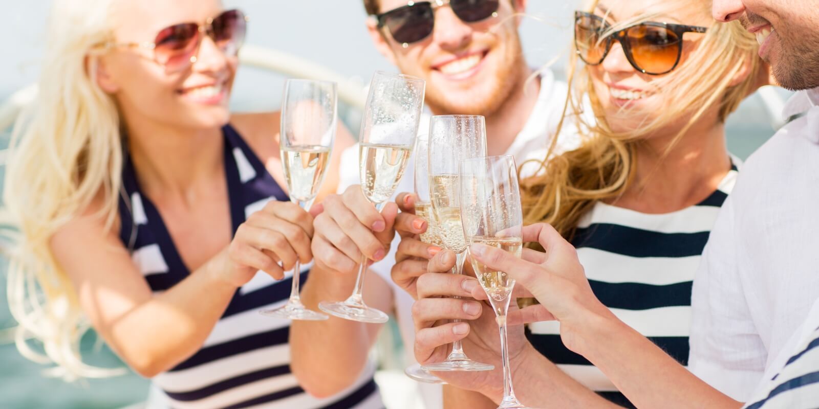 https://www.talamare.com/medias/A group of charter guests drinking champagne on the deck of a luxury yacht for over 12 people