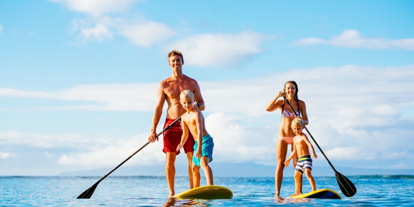 https://www.talamare.com/medias/A couple and their kids exploring the waters of the Mediterranean with the  paddle boards of their charter yacht