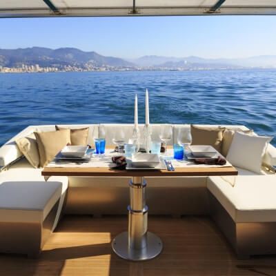 A table set up for lunch on the aft deck of a luxury charter yacht available on the French Riviera