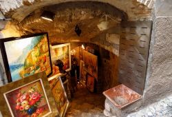 Paintings on display in front of an art gallery in the hilltop village of Saint-Paul-de-Vence