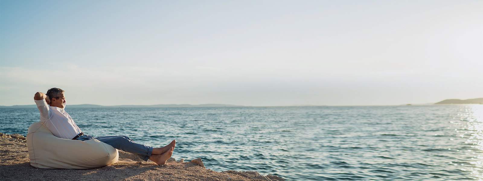 A yacht owner enjoying a relaxing moment with a panoramic view of the sea